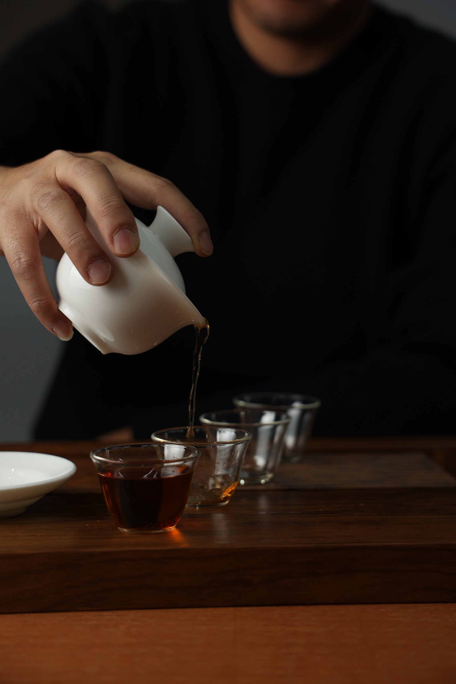 Tea being poured into a glass cup